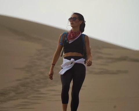 Bukitt's co-founder Mariana Riquezes walking on a dune at Great Sand Dunes.