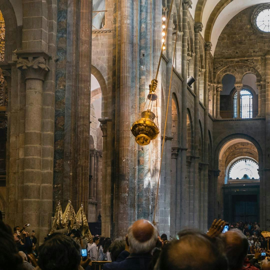 The Botafumeiro swinging over the heads of pilgrims at the Santiago Cathedral.