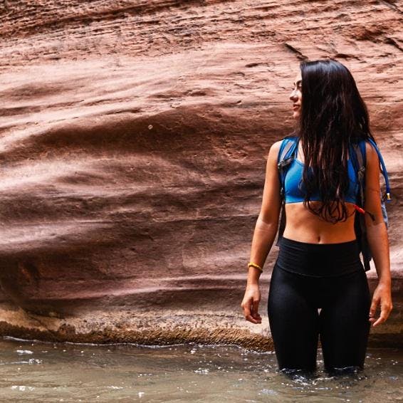 Co-founder Mariana Riquezes standing in a river at the Narrows.