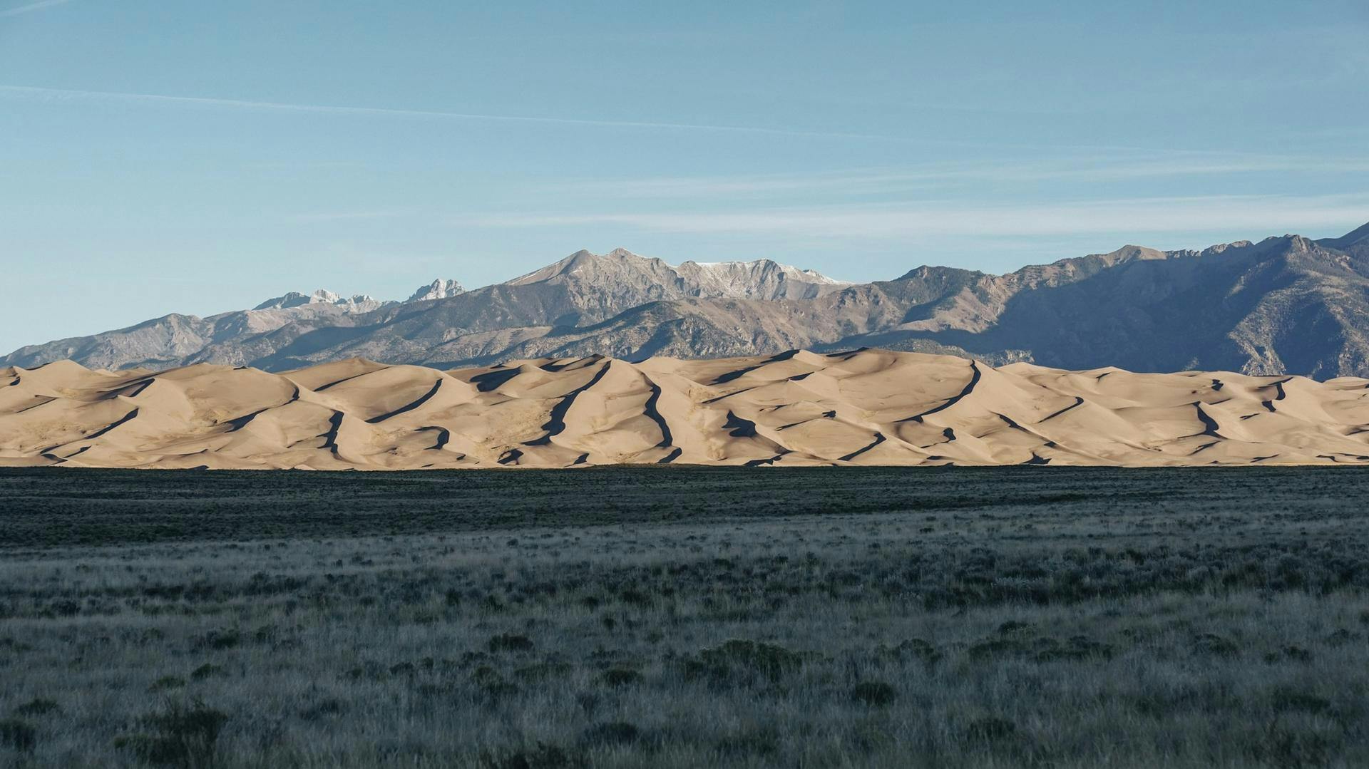 Sand dunes in front of a mountain range at Great Sand Dunes National Park.